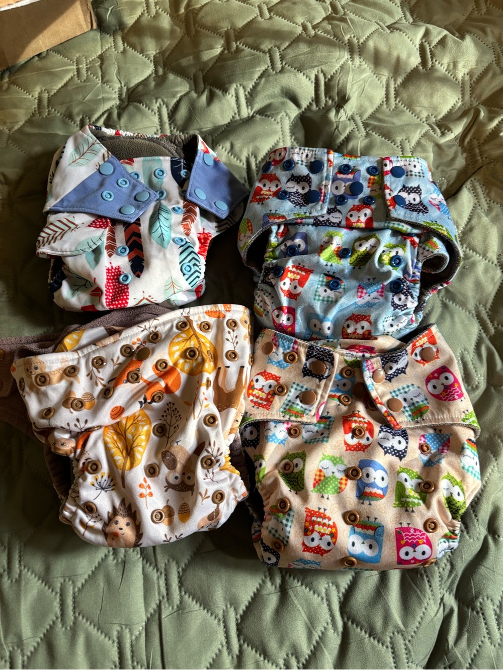 4 Happy Flute All in One cloth pocket diapers.